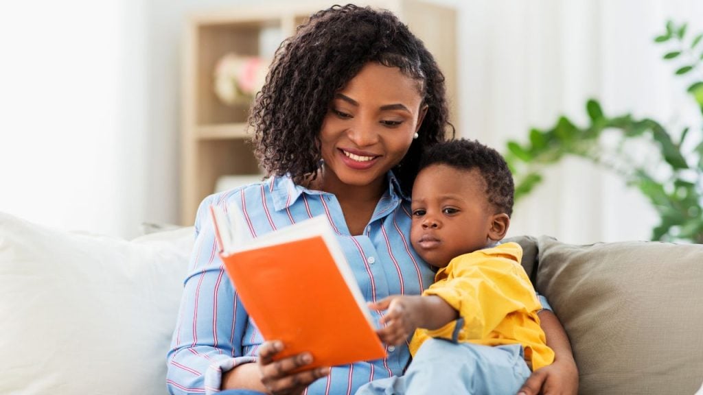 mom reading book to child