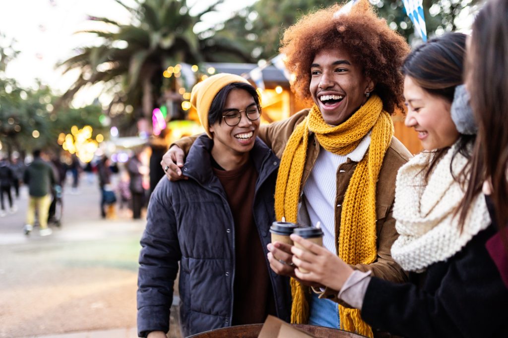 Happy young diverse friends enjoying winter holidays